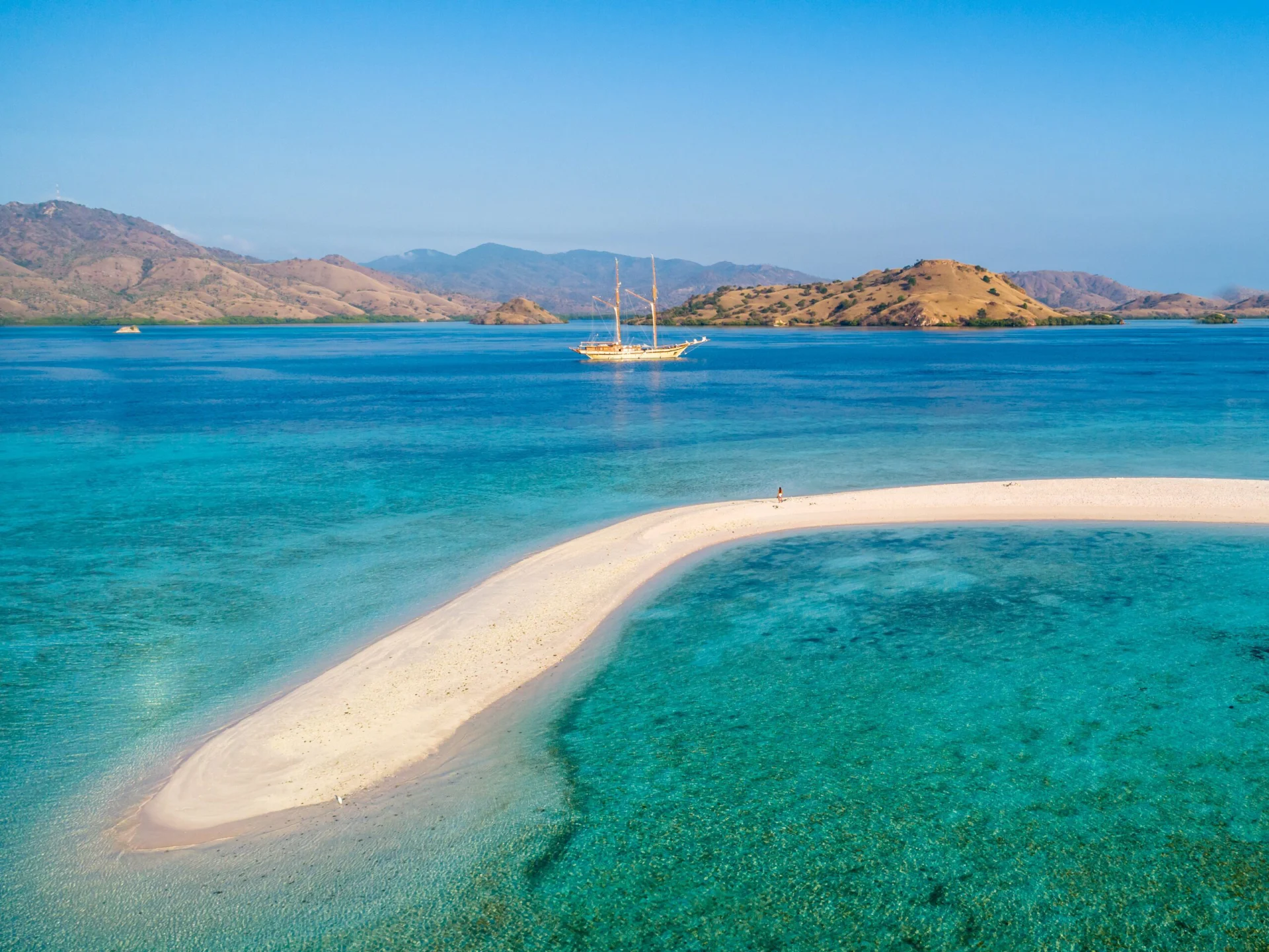 Luxury Phinisi sailing through islands